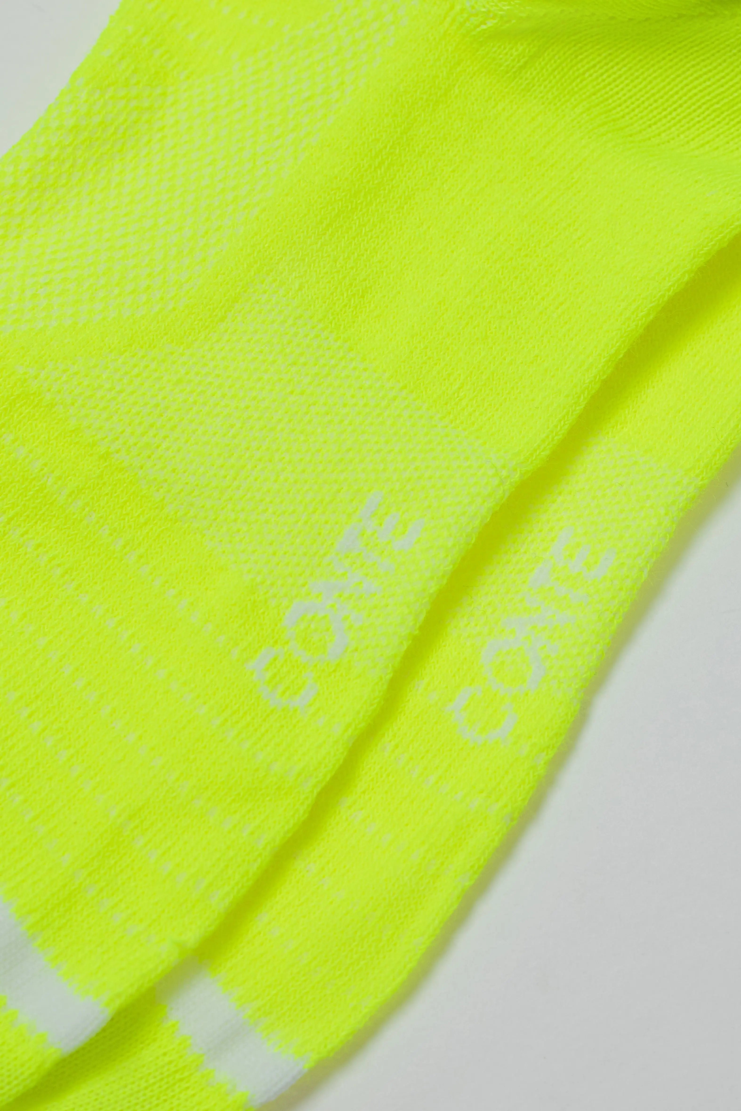 Neon yellow socks with 'Conte' branding on a light gray background #color_lime-green