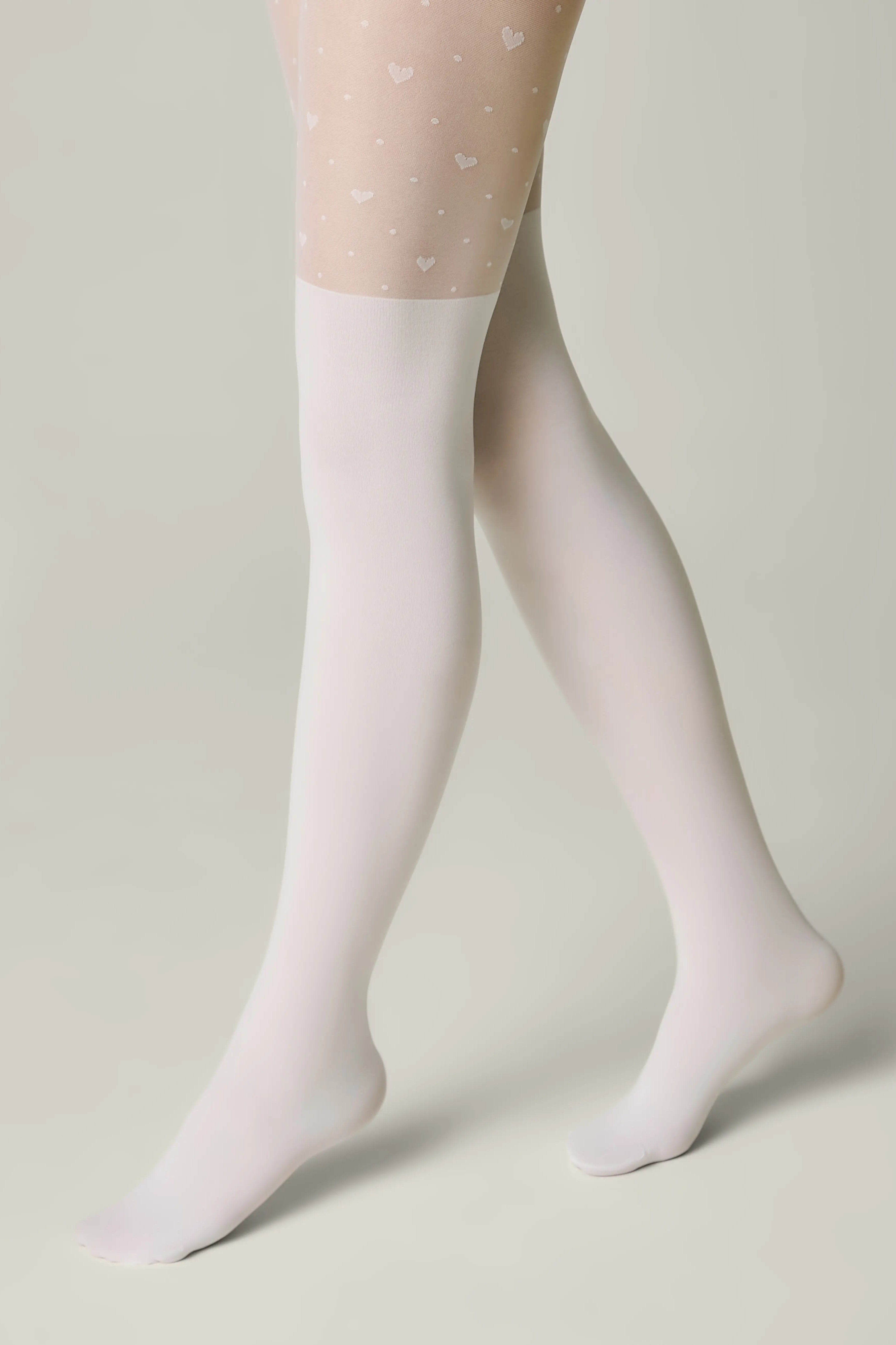 White tights with heart patterns on a neutral background #color_bianco