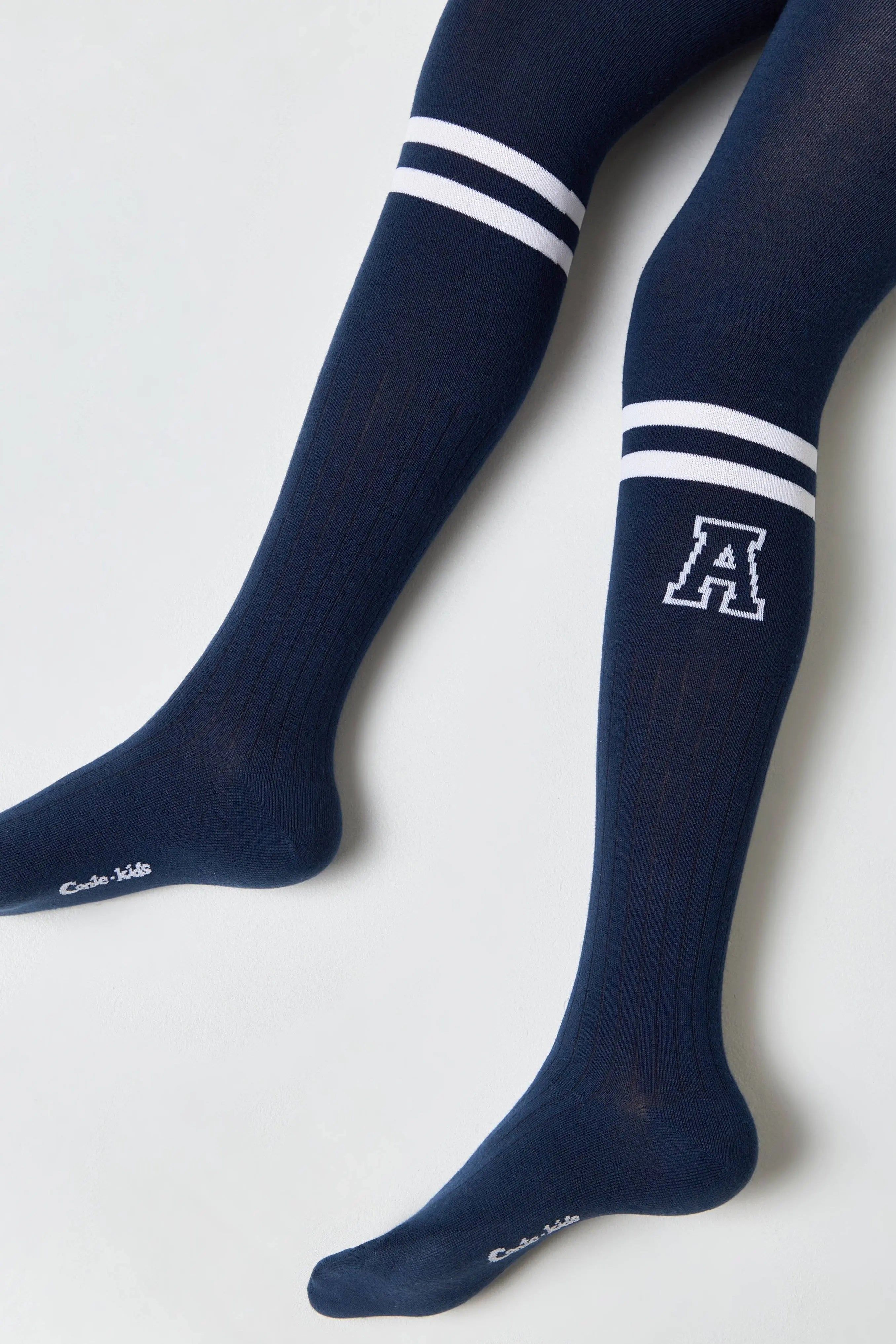 Navy knee-high socks with white stripes and a logo on a white background