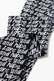 Black and white patterned fabric with 'love and hope' text on a white background #color_nero-bianco