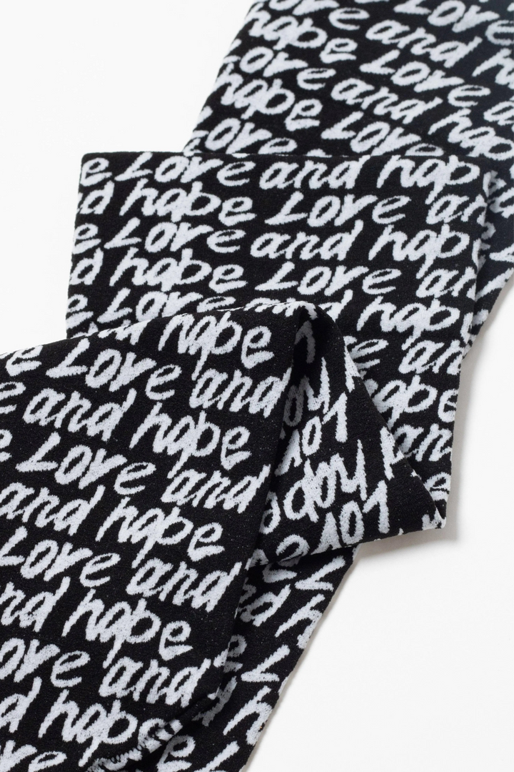 Black and white patterned fabric with 'love and hope' text on a white background #color_nero-bianco